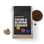 Front view of bag of Crunch On Cacao & Almond Cookies, with cookie, chocolate and almonds in the background